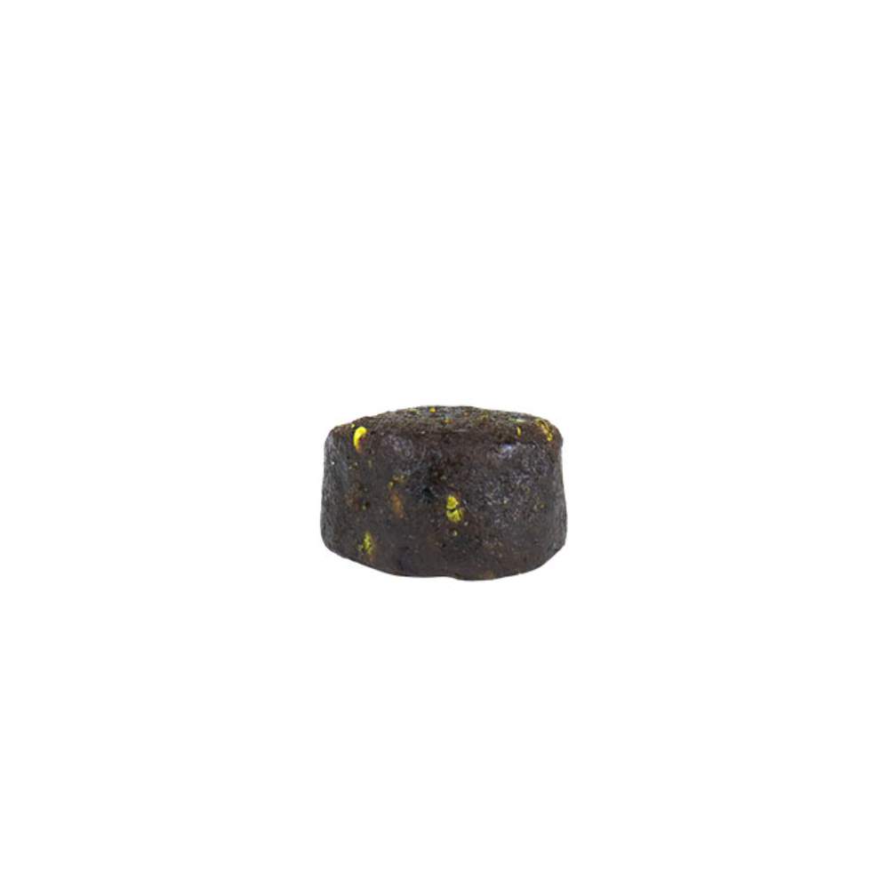 A single ALZOO Plant-Based Hip & Joint Soft Chew, focusing on its round shape and dark color with small yellow specks