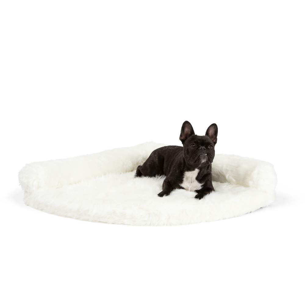 A small black dog with white markings is resting on the Polar White Paw PupRug™ Memory Foam Corner Dog Bed, isolated on a white background