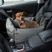 A small dog is sitting happily in the front passenger seat of a car in the Paw PupProtector™ Faux Leather Memory Foam Dog Car Bed - Slate Gray Single Seat Car Dog Beds