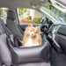 A small fluffy dog is sitting happily in the front seat, safely placed in the Paw PupProtector™ Faux Leather Memory Foam Dog Car Bed - Black Single Seat Pet Bed