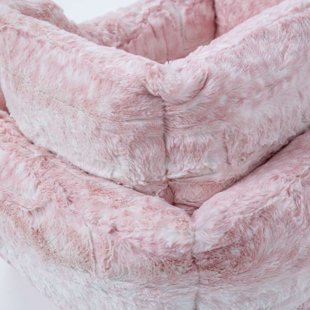 A soft, pink Hello Doggie Cashmere Dog Bed with a fur-like texture, providing a cozy and elegant spot for pets to relax