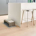 Bowsers Fossil Artisan Wood Feeder Double sits neatly on a floor mat beside a kitchen island with two raised white ceramic bowls