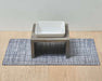 Bowsers Gourmet Placemat For Artisan Dog Feeder under a raised wooden dog bowl stand with a white ceramic dish on light wood flooring