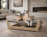 Bowsers Yugen Pet Lounger White Oak is displayed indoors with a dog resting on a raised cushioned bed in a stylish living room near a fireplace