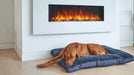 Brown dog sleeps peacefully on a navy blue Bowsers Dream Futon Dog Bed placed in front of a modern fireplace