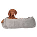 Brown dog relaxes in a soft cloud cushion, resting one paw over the edge of Bowsers The Franklin Dog Bed