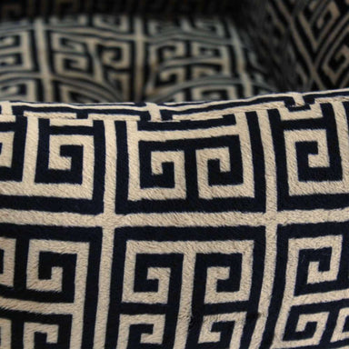Close-up view of the fabric pattern on the Hello Doggie Obsidian Dog Bed, showcasing the intricate black and tan Greek key design