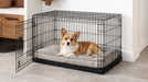 Corgi relaxes inside a black wire crate on Bowsers Luxury Crate Mattress Dog Bed with a cozy gray patterned cushion