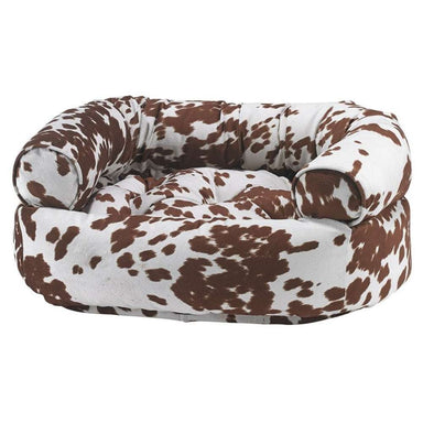 Durango Bowsers Double Donut Bed in brown-and-white cow print with a soft padded center and supportive raised edges