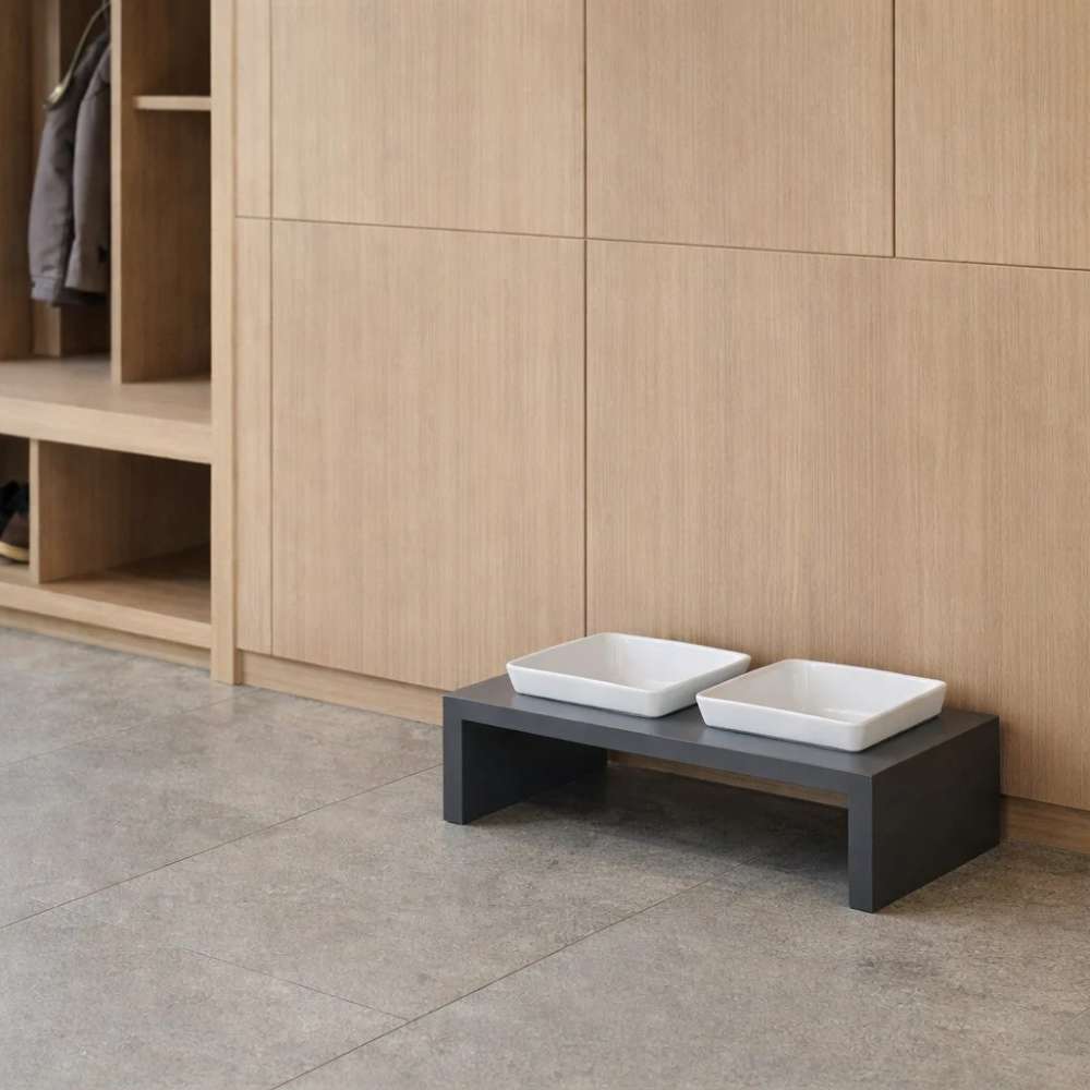 Empty elevated feeding station with two square white bowls sits neatly on the floor, showcasing the simple design of Bowsers Moderno Wood Feeder
