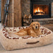 Golden retriever lies comfortably on a soft, fur-lined rectangular bed near a lit fireplace, enjoying the warmth on Bowsers The Dude Dog Bed