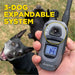 Handheld remote with dogs in the background shows Dogtra 280X Remote Trainer 1 Dog System as a 3-dog expandable training system