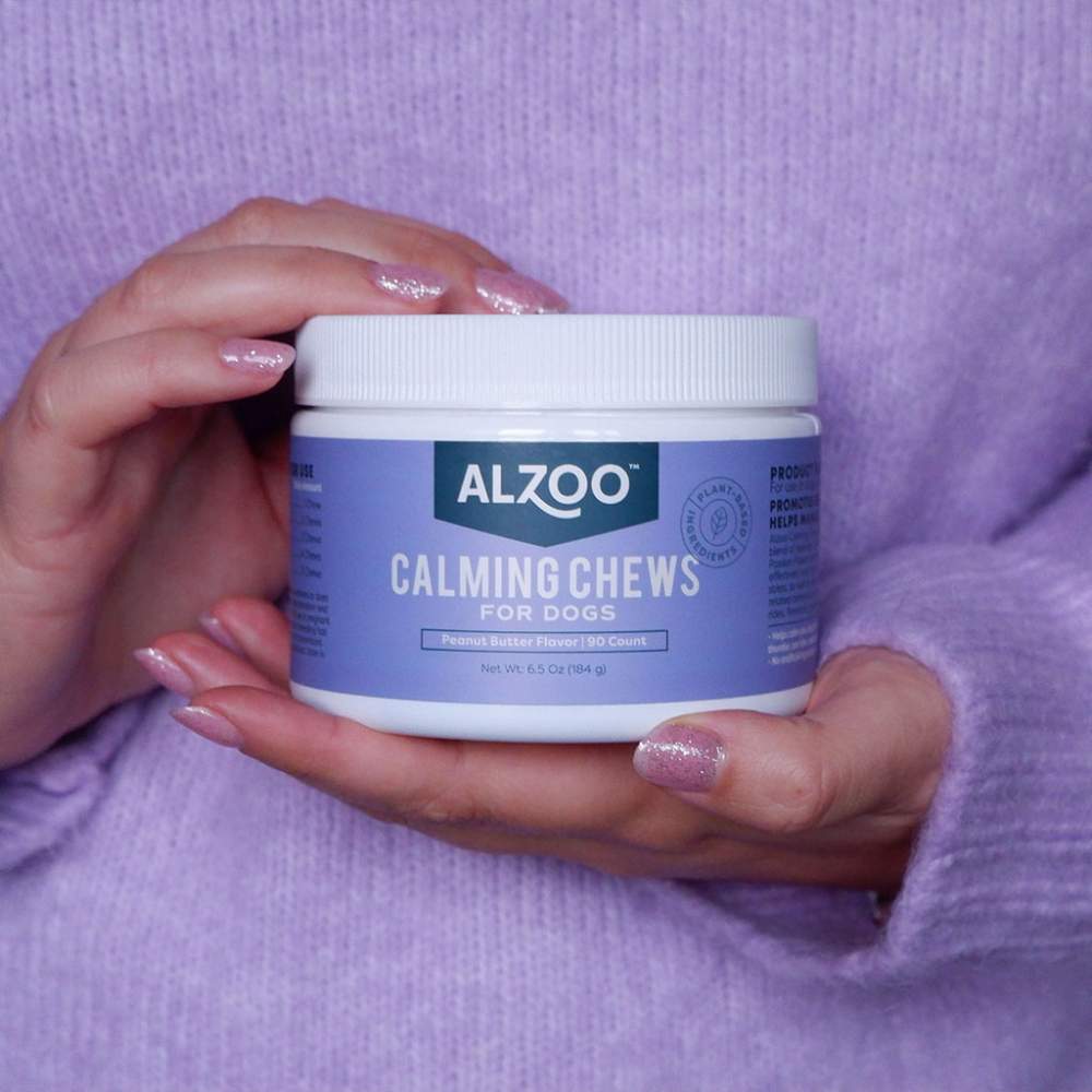 Hands holding a container of ALZOO Plant-Based Calming Soft Chews