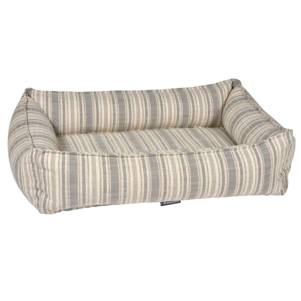 Harper Stripe Bowsers Urban Lounger Dog Bed in beige and gray striped fabric with cushioned bolsters