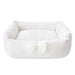 Hello Doggie Dolce Dog Bed in ivory color, featuring a plush, knitted texture with a decorative bow and a small crown emblem in the center