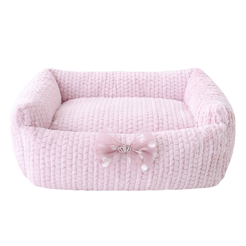 Hello Doggie Dolce Dog Bed in rosewater color, showcasing a soft, knitted design with a charming bow and a small crown emblem in the middle
