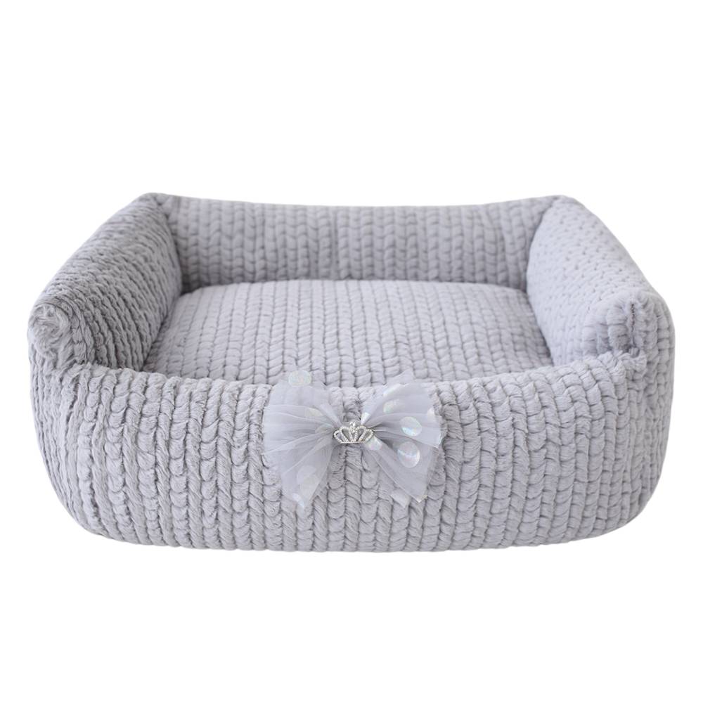 Hello Doggie Dolce Dog Bed in sterling gray color, displaying a cozy, knitted fabric with a delicate bow and a small crown emblem at the center