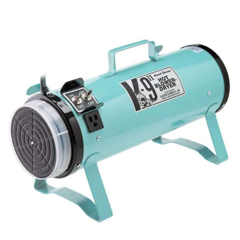 Light blue K-9 II Dog Dryer is a portable cylindrical pet dryer with a front filter, sturdy legs, and carry handle