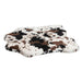 Longhorn Bowsers Maverick Rugbed is a soft white, brown, and black spotted faux fur mat resembling a cowhide pattern