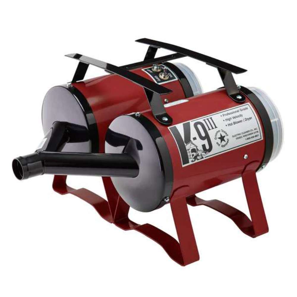 Maroon K-9 III Dog Dryer shows a front air nozzle, glossy cylindrical design, and elevated legs for professional pet grooming