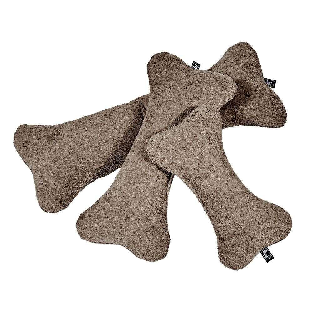 Mocha Bowsers Bumper Bone Pillow brown fuzzy bone dog toys casually stacked together on a light background