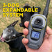 Person holds the remote in front of two dogs, showing the system can expand to train multiple dogs with Dogtra 280X Remote Trainer 2 Dog System