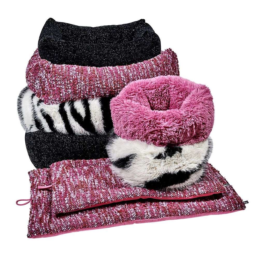 Pile of cozy Bowsers The Muffy Dog Bed options in pink, zebra print, and black, stacked with matching mats