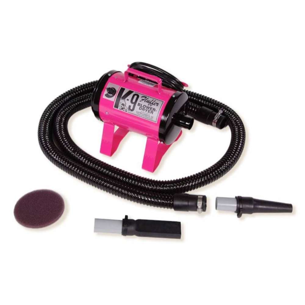 Pink K-9 Fluffer Dryer with a flexible black hose and detachable grooming nozzles is shown for pet grooming use