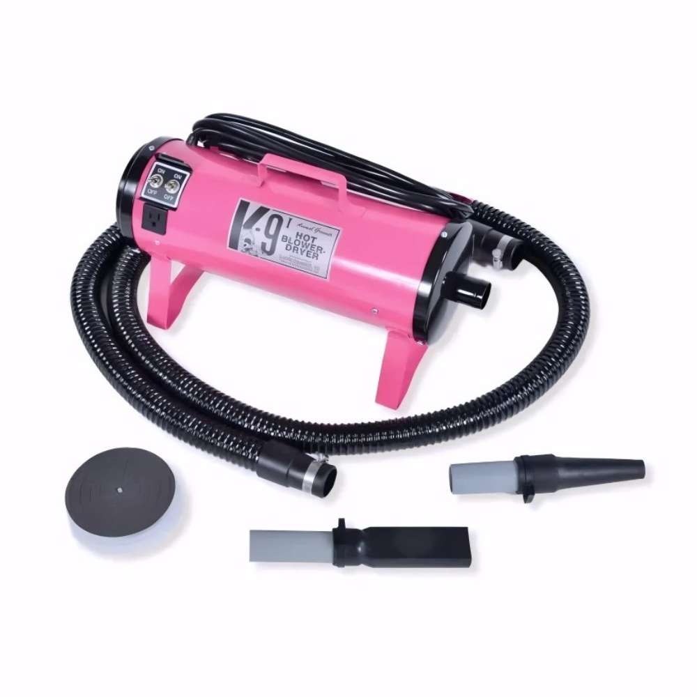 Pink K-9 I Dog Dryer with a flexible black hose and detachable grooming nozzles is arranged neatly on a white surface