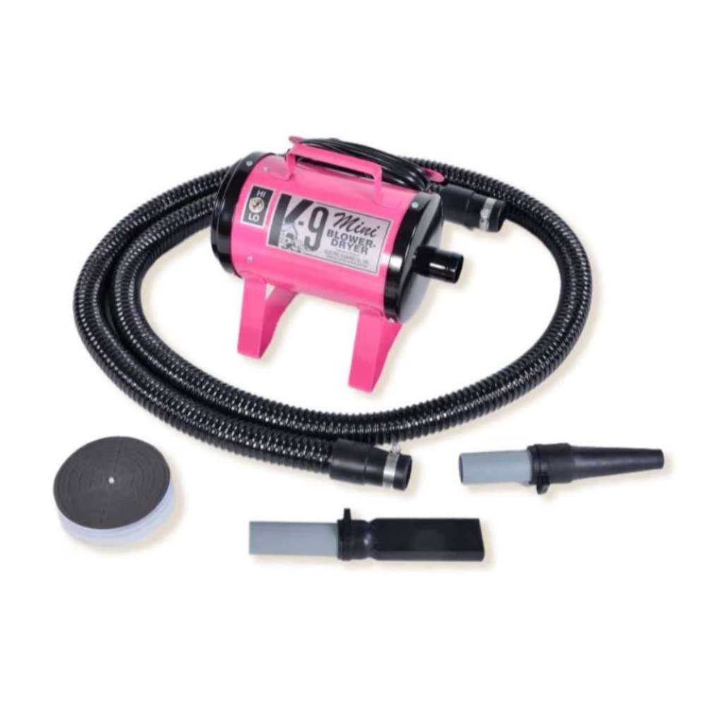 Pink K-9 Mini Dog Dryer is a portable pet dryer with a vibrant pink finish, black hose, and detachable grooming nozzles