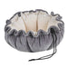 Pumice Bowsers Buttercup Dog Bed in soft gray fabric with a fluffy cream interior and raised nesting walls