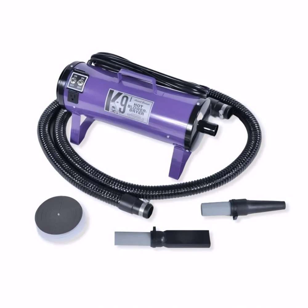 Purple K-9 I Dog Dryer with a coiled black hose and two nozzle tips is shown against a simple white backdrop