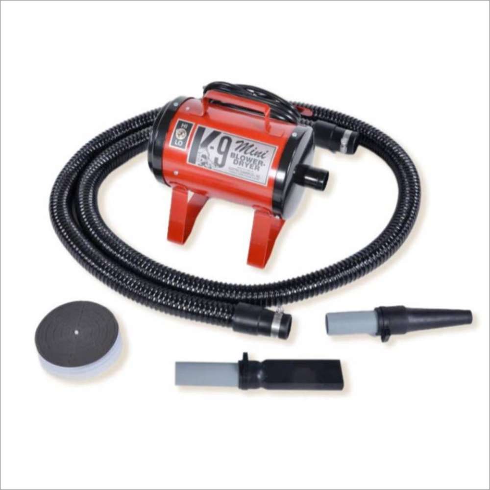 Red K-9 Mini Dog Dryer is a small red pet grooming dryer equipped with a flexible hose, filter cover, and interchangeable nozzles