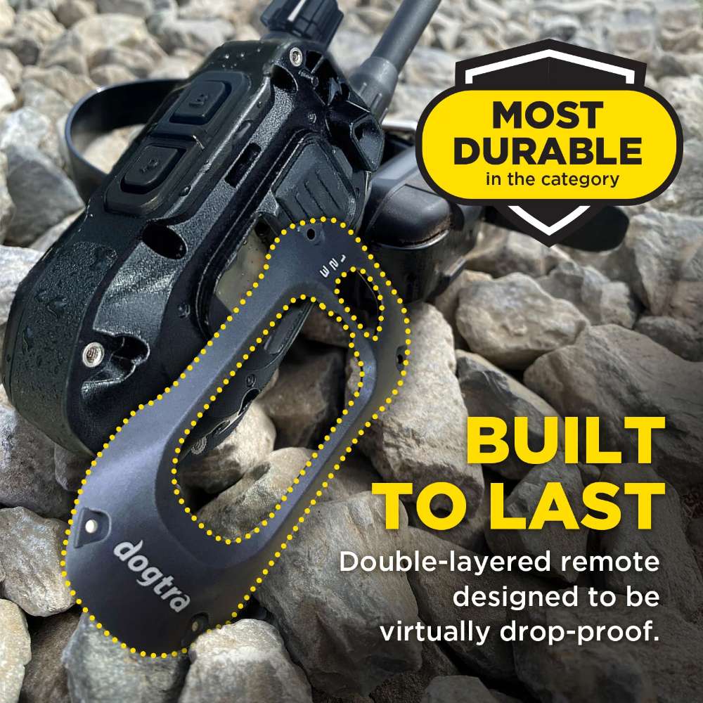 Remote lies on rough rocks, emphasizing its rugged, drop-resistant build as part of Dogtra 280X Remote Trainer 2 Dog System