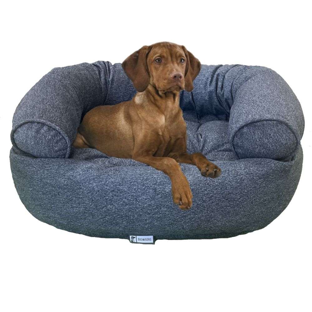 River Bowsers Double Donut Bed in textured blue-gray fabric with a brown puppy relaxing on the cushioned center