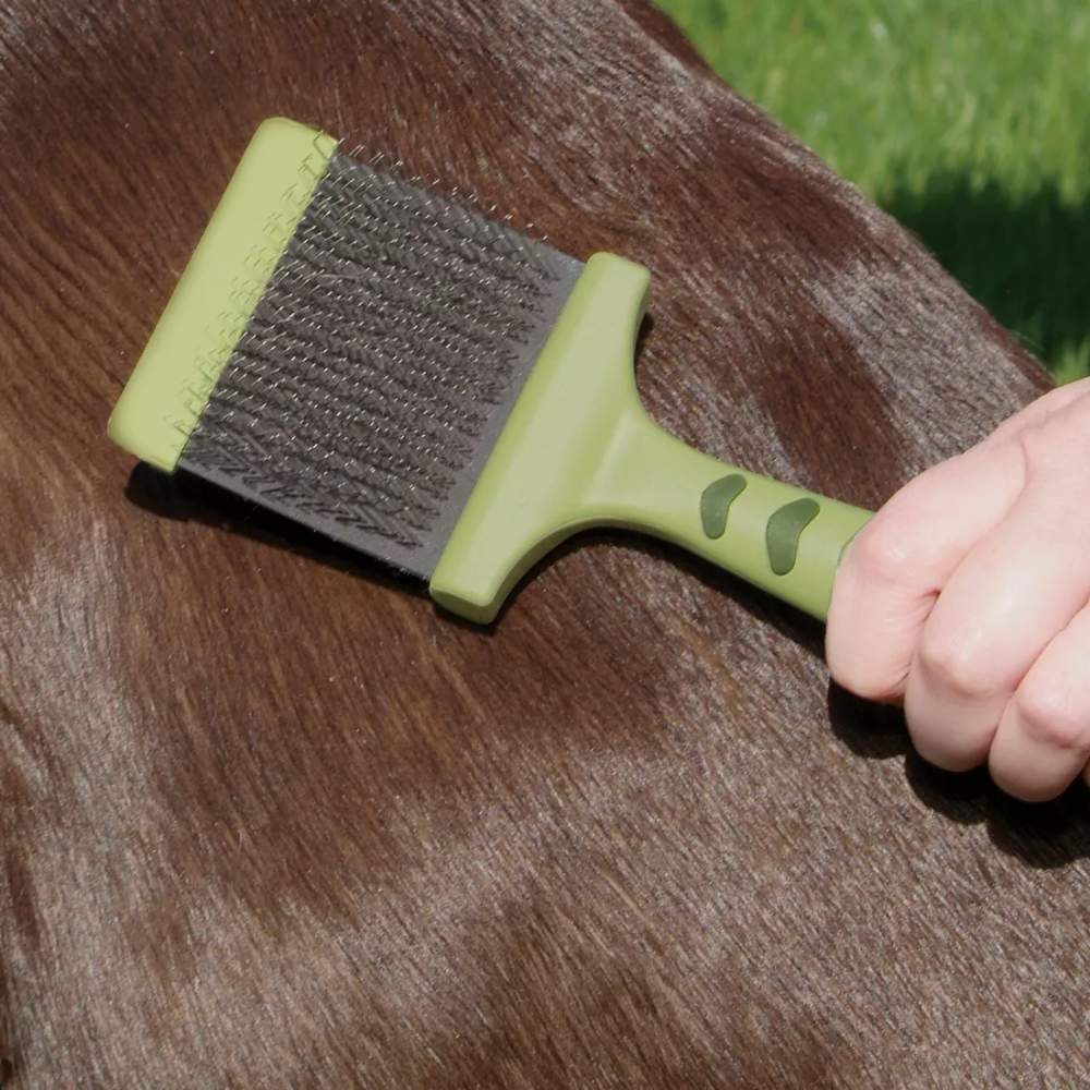 Safari Dog Flexible Slicker Brush - Medium by Coastal Pet Products is being used to brush a brown dog's coat