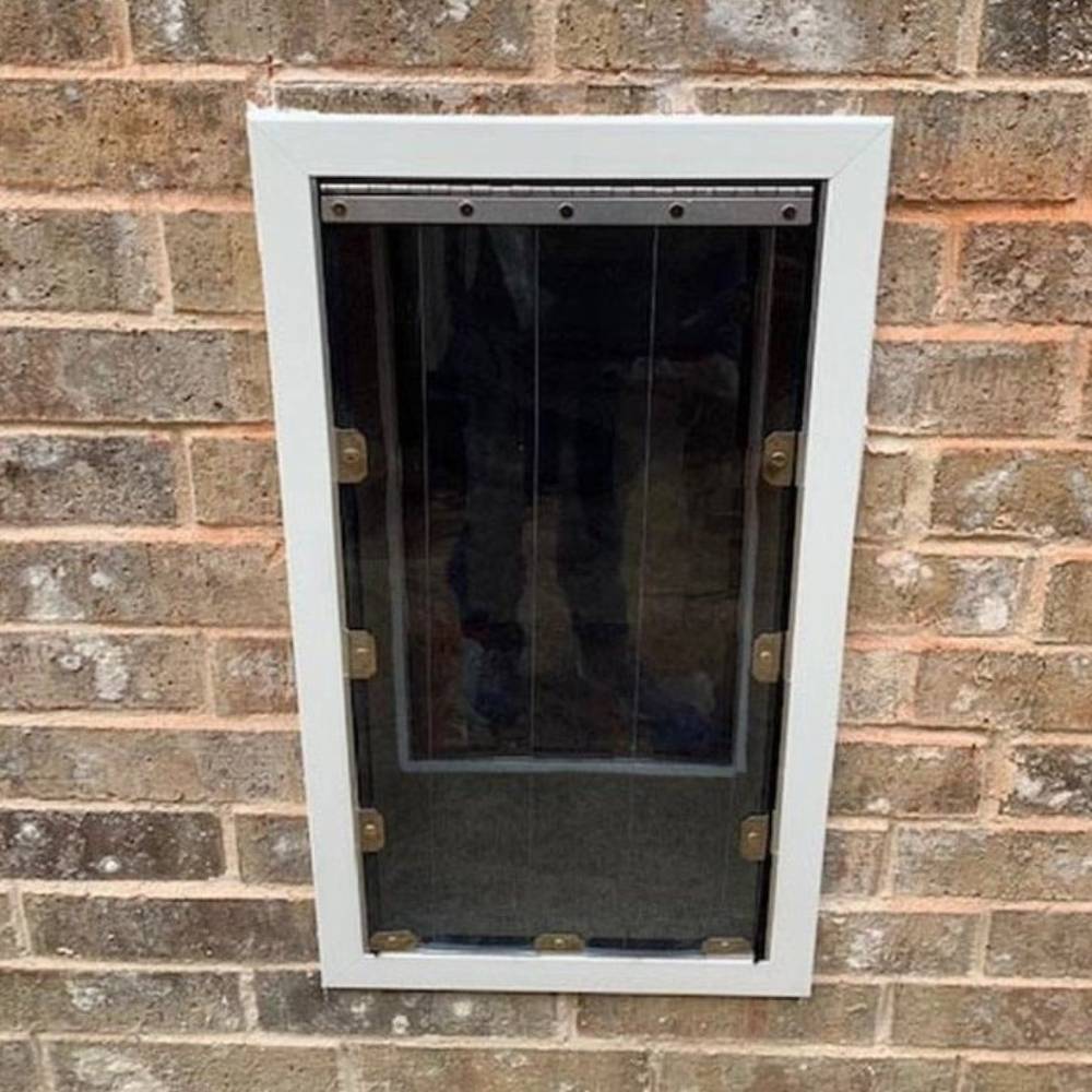 Security Boss MaxSeal PRO Pet Door for Walls - Installed outside view on a brick wall, highlighting the robust construction