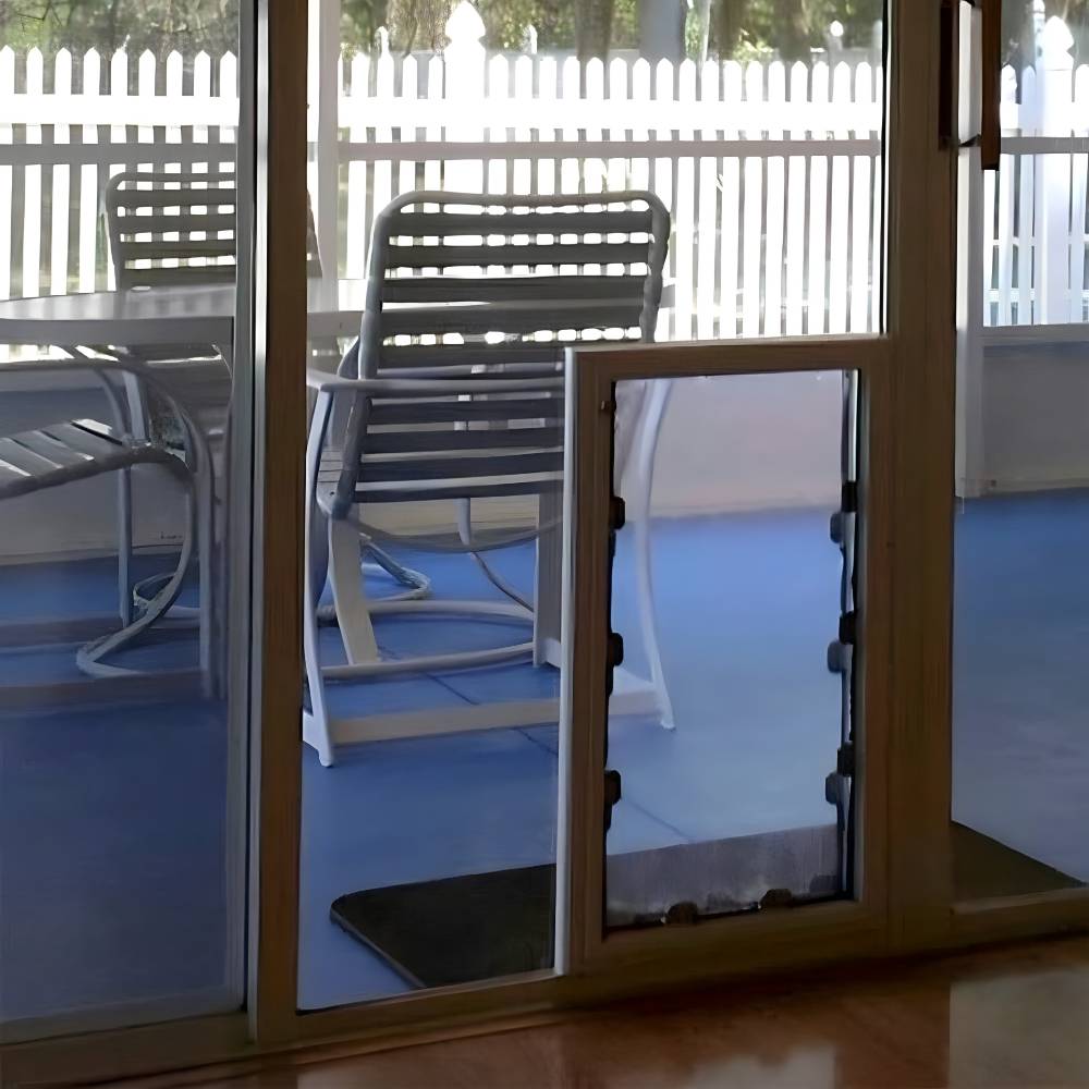 Side view of the Security Boss MaxSeal In-Glass Dog Door installed in a sliding glass door, demonstrating its seamless integration into home decor