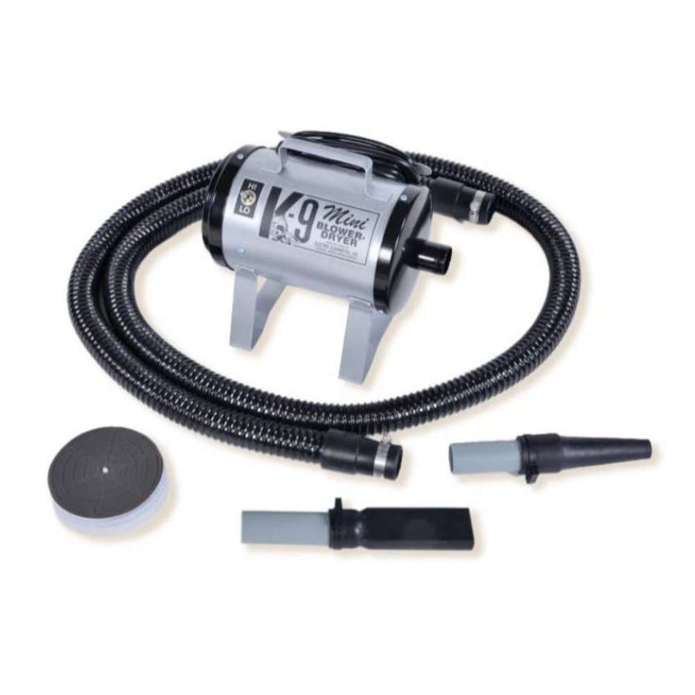 Silver K-9 Mini Dog Dryer is a sleek metallic pet dryer with a black hose and multiple grooming attachments for controlled airflow