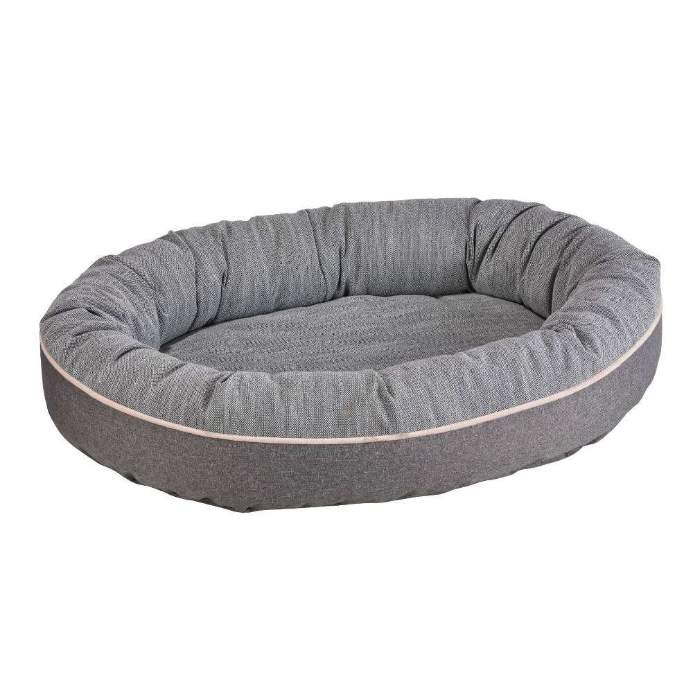 Stone Grey Bowsers Ovie Dog Bed featuring a gray oval dog bed with thick padded sides and a soft cushioned center
