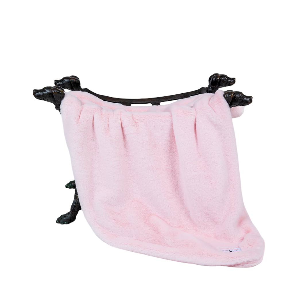 The Hello Doggie Big Baby Dog Blanket in ice pink is neatly displayed on a stand with four dog-shaped legs, highlighting its light pink hue