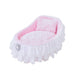 The Hello Doggie Crib Dog Bed in pink, designed with a charming cradle shape, soft pink fabric, and delicate white lace ruffles, completed with a sparkling brooch