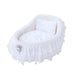 The Hello Doggie Crib Dog Bed in white, highlighting a plush, cushioned interior with delicate lace ruffles and an elegant brooch