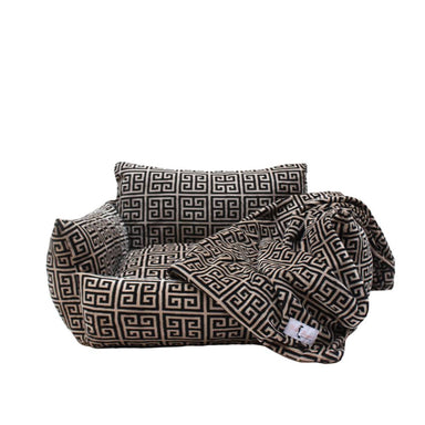 The Hello Doggie Obsidian Dog Sofa Bed with a matching blanket set, displaying a luxurious black and tan geometric Greek key pattern, perfect for providing extra comfort and warmth