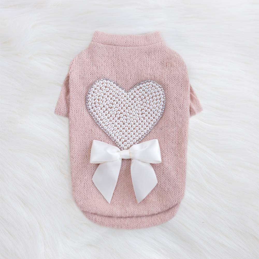 The Hello Doggie Pearl Heart Dog Sweater in peach color features a heart made of pearls with a white bow underneath