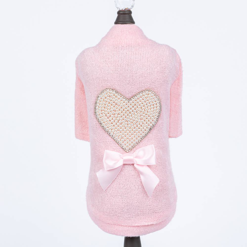 The Hello Doggie Pearl Heart Dog Sweater in pink color is modeled on a dog mannequin, featuring a pearl heart and a pink bow on the back