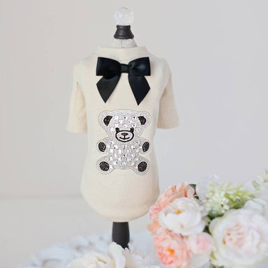 The Hello Doggie Teddy Bow Tee is a cream-colored dog tee adorned with a black satin bow and a sparkling crystal teddy bear design