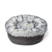 The Ultra Plush Arctic Fox Paw PupPouf™ Luxe Faux Fur Donut Dog Bed is shown in a pristine state, highlighting its plush design