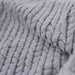 The close-up image emphasizes the detailed texture and luxurious feel of the Hello Doggie Paris Dog Blanket in sterling