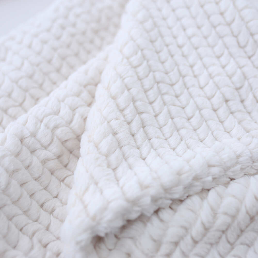 The close-up image highlights the texture and softness of the Hello Doggie Paris Dog Blanket in ivory